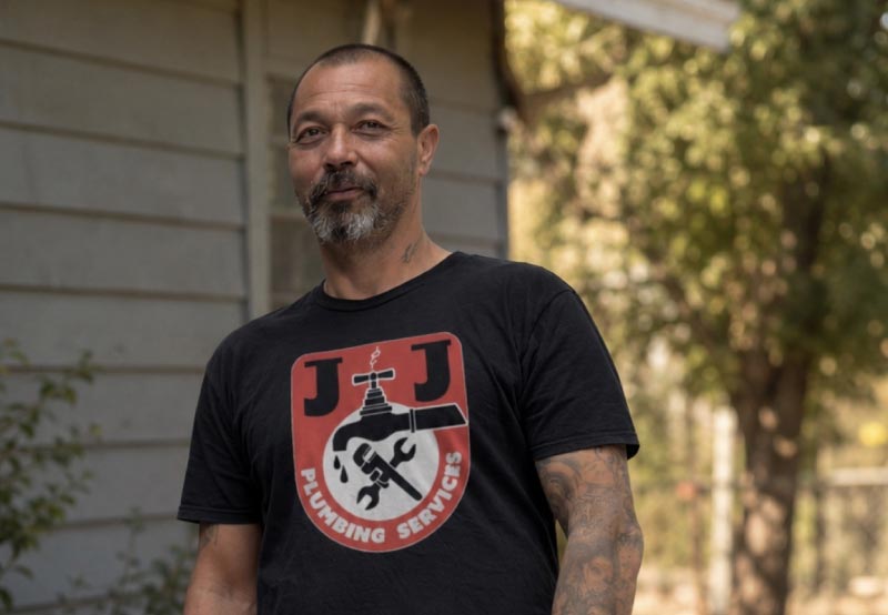 Portrait of Joe Pergis, owner of J&J Plumbing Services, standing outside a Bakersfield home